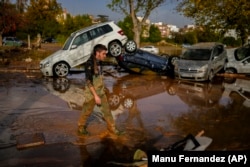 Flooded cars are piled up in Utiel, Spain, Wednesday, Oct. 30, 2024. (AP Photo/Manu Fernandez)