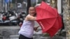 In this photo released by Xinhua News Agency, a man holding an umbrella struggles against the wind following the landfall of typhoon Yagi in Haikou, south China's Hainan Province, Sept. 6, 2024. 