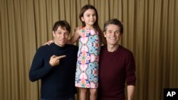 In this Sept. 9, 2017 photo, writer-director Sean Baker, from left, actress Brooklynn Prince and actor Willem Dafoe pose together to promote their film, "The Florida Project," during the Toronto International Film Festival in Toronto.