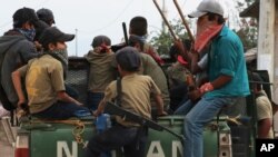 Niñospatrullan su comunidad a bordo de una camioneta como parte de una exhibición de líderes comunitarios para llamar la atención del gobierno sobre la difícil situación de su pueblo en Ayahualtempa, Guerrero, México.