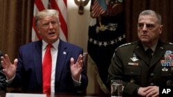 President Donald Trump, joined by from left, Defense Secretary Mark Esper, and Chairman of the Joint Chiefs of Staff Gen. Mark Milley, speaks during a briefing with senior military leaders in the Cabinet Room at the White House, Oct. 7, 2019.