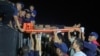 An injured fisherman is carried on a stretcher at a port in Ranong in Thailand near the Myanmar border in this handout photo taken Nov. 30, 2024 and released Dec. 2.