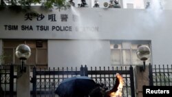 一名反送中抗议者向香港尖沙咀警察署投掷燃烧瓶。 （2019年10月20日）