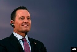 FILE - Ambassador Richard Grenell listens to Serbian President Aleksandar Vucic during a press conference after their meeting, in Belgrade, Serbia, Jan. 24, 2020.