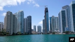 FILE - The skyline of Miami is seen at the entrance to the Miami River from a boat on Biscayne Bay, May 9, 2022.