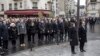 French President Francois Hollande and Paris Mayor Anne Hidalgo stand at attention after unveiling a plaque near the Petit Cambodge and Carillon cafes in Paris, France, during a ceremony held for the victims of last year's attacks, Nov. 13, 2016.