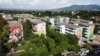 A drone view shows some of the buildings in the Zacamil neighborhood that is being worked on by the Zacamil Project, an initiative led by a Salvadoran foundation that seeks to decorate humble and once violent communities with art, in Mejicanos, El Salvador, July 18, 2024.