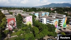 A drone view shows some of the buildings in the Zacamil neighborhood that is being worked on by the Zacamil Project, an initiative led by a Salvadoran foundation that seeks to decorate humble and once violent communities with art, in Mejicanos, El Salvador, July 18, 2024.