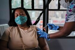 A person receives a dose of the Pfizer-BioNTech vaccine for COVID-19, at a mobile inoculation site in the Bronx borough of New York City, New York, August 18, 2021.