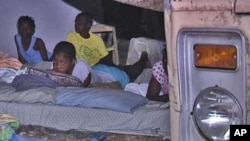 Haitian family sleeping outside after earthquake