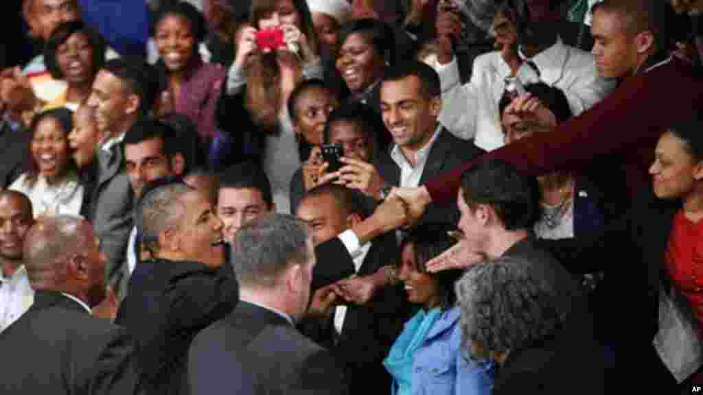 U.S. President Barack Obama greets the public as he arrives at a town hall meeting with young African leaders at the University of Johannesburg..