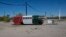 FILE - A bus painted in a Mexican flag motif and a banner with the Spanish farewell for "have a nice trip," serves as a roadside advertisement for a Chevron station, in Ajo, Arizona, April 4, 2017. In the past month, three large groups of migrants have been found in the desert near Ajo.