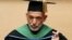 Afghan President Hamid Karzai, wearing an academy gown, delivers a speech as he receives an honorary doctorate at Nippon Sport Science University in Tokyo, July 9, 2012. 