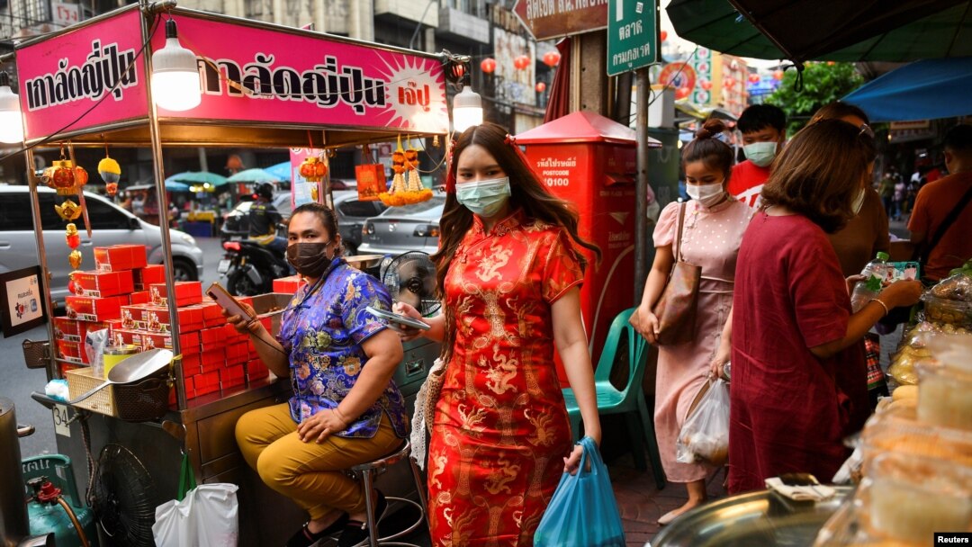 People walk on the street as they prepare for the Lunar New Year celebration at the Chinatown in Bangkok, Thailand, Feb. 10, 2021.
