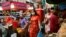 People walk on the street as they prepare for the Lunar New Year celebration at the Chinatown in Bangkok, Thailand, Feb. 10, 2021.
