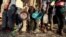 FILE - Ethiopian refugees who fled the country's restive Tigray region queue to receive food aid at the Um-Rakoba camp in Al-Qadarif state, in Sudan, Dec. 11, 2020.