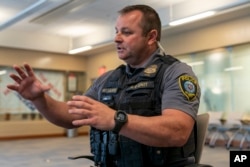 Sgt. Matt Gilmore gestures as he talks about using Axon's Draft One AI software during an interview at Oklahoma City police headquarters on Friday, May 31, 2024 in Oklahoma City, Oklahoma. (AP Photo/Nick Oxford)