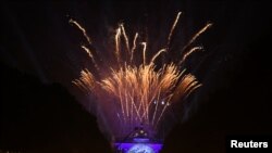 Fireworks explode over Brandenburg Gate during a ceremony marking the 30th anniversary of the fall of the Berlin Wall in Berlin, Germany, Nov. 9, 2019. 
