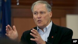 FILE - Washington Gov. Jay Inslee speaks to students at Saint Anselm College in Manchester, N.H., Jan. 22, 2019.