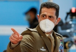 FILE - Italy's special COVID-19 commissioner General Francesco Paolo Figliuolo gestures during a visit to a mass vaccination centre at Fiumicino Airport near Rome, Italy, March 12, 2021.