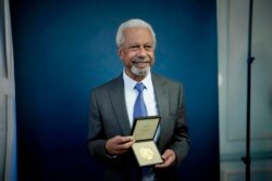 Abdulrazak Gurnah, a Tanzanian-born novelist and emeritus professor who lives in the UK, poses for photographs with his 2021 Nobel Prize for Literature medal, in London, Dec. 6, 2021.