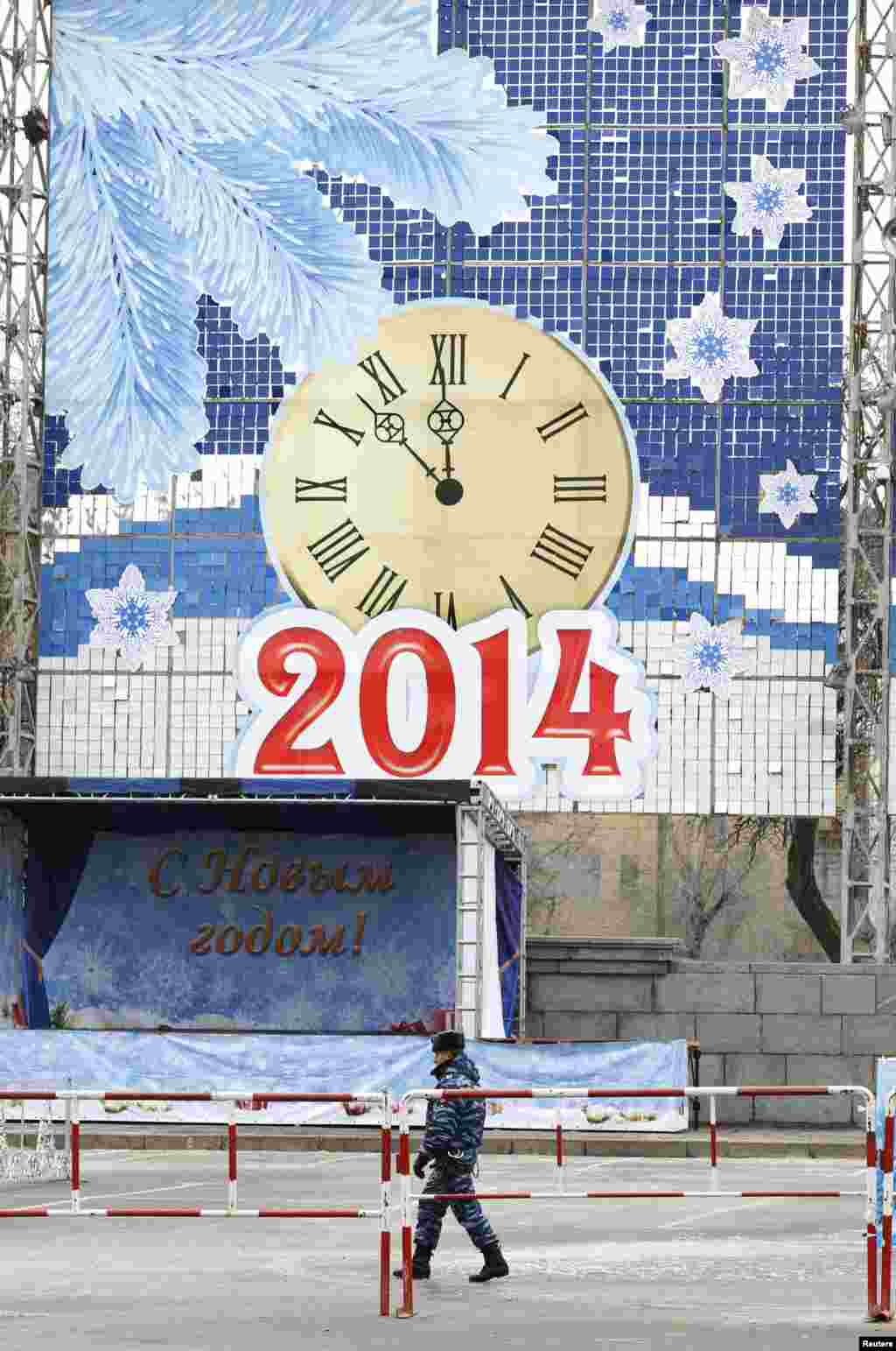 A policeman patrols a street with New Year&#39;s decorations, central Volgograd, Russia, Jan. 1, 2014.