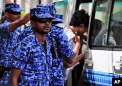 FILE - Maldivian police force on guard after the arrest of Vice President Ahmed Adeeb in Male, Maldives, Oct. 24, 2015.