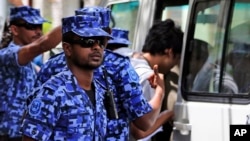 FILE Maldivian police force guard after the arrest of Vice President Ahmed Adeeb in Male, Maldives, Oct. 24, 2015.