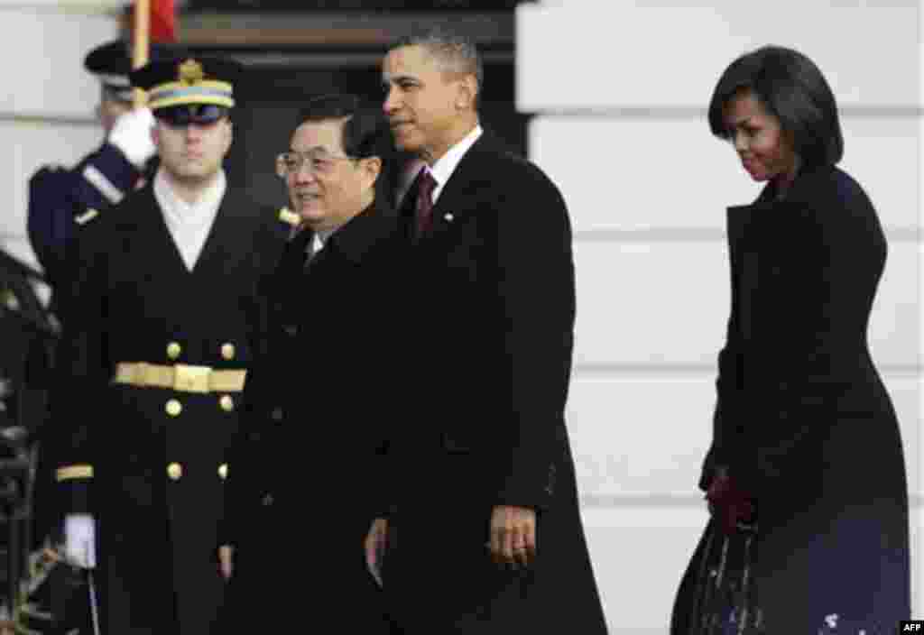 President Barack Obama and first lady Michelle Obama welcome China's President Hu Jintao during a state arrival on the South Lawn of the White House in Washington, Wednesday, Jan. 19, 2011. (AP Photo/Charles Dharapak)