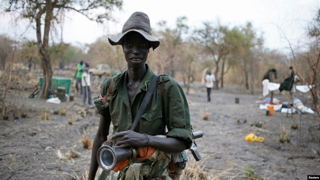 A rebel fighter carries a rocket-propelled grenade (RPG) in a rebel camp in Jonglei state.