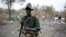 A rebel fighter carries a rocket-propelled grenade (RPG) in a rebel camp in Jonglei state.