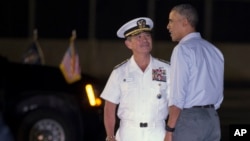 President Barack Obama, right, is greeted by Commander of the U.S. Pacific Command Adm. Harry Harris after arriving at Joint Base Pearl Harbor-Hickam, in Honolulu, Hawaii, Dec. 19, 2015.