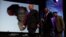 FILE - Trombonist and composer Jonas Gwangwa, right, walks on stage trumpeter Hugh Masekela (L) and Caiphus Semenya after paying tribute during Miriam Makeba's memorial service in Johannesburg November 15, 2008.