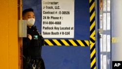 An Asian American New York City Police officer patrols inside the "7" train station beneath a heavily trafficked section of Main Street in Flushing, a largely Asian American neighborhood, Tuesday, March 30, 2021, in the Queens borough of New York…