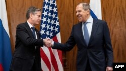 US Secretary of State Antony Blinken (L) and Russian Foreign Minister Sergey Lavrov shake hands before their meeting on January 21, 2022, in Geneva, Switzerland.