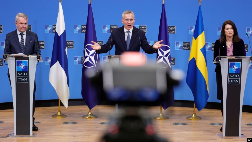 NATO Secretary General Jens Stoltenberg, center, participates in a media conference with Finland's Foreign Minister Pekka Haavisto, left, and Sweden's Foreign Minister Ann Linde, right, at NATO headquarters in Brussels, Monday, Jan. 24, 2022. (AP Photo/Olivier Matthys)