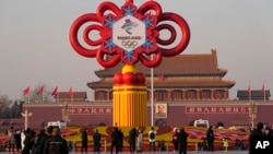 지난 18일 중국 베이징 톈안먼 광장 방문객들이 동계올림픽 조형물을 바라보고 있다. 