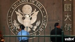 People waiting to apply for visas sit outside the U.S. embassy in Beijing May 3, 2011. China has joined governments hailing the death of Osama bin Laden, putting aside friction with Washington and saying China is also a victim of terror. Beijing and Washington have gone through b