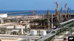 FILE - Oil and gas installations are found throughout Libya. This one, built by the Italian ENI group, is on the coast near Mellitah, Libya.