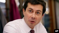 FILE - Pete Buttigieg, mayor of South Bend, Indiana, talks with a reporter at Farmers Market in South Bend, Ind., Jan. 10, 2019.