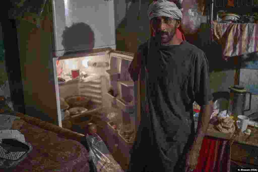 Mohamed, a father of five, shows his largely empty refrigerator. &ldquo;We use the refrigerator for practically just cooling water these days.&rdquo;