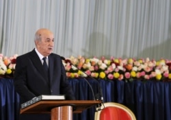 FILE - Algerian President Abdelmadjid Tebboune takes the oath during a swearing-in ceremony in Algiers, Algeria, Dec. 19, 2019.