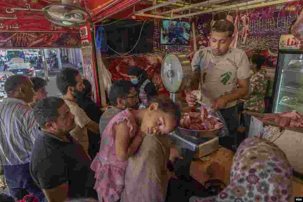 Customers line up at a butcher&#39;s shop to buy meat for the holiday, July 19, 2021. 