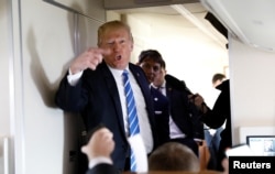 U.S. President Donald Trump speaks to reporters aboard Air Force One after visiting White Sulphur Springs, W.Va., April 5, 2018.