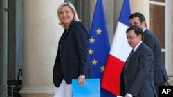 FILE - From left, Marine Le Pen, Jean-Francois Jalkh and Florian Philippot of the National Front party arrive at the Elysee Palace for a meeting with French President Francois Hollande in Paris, May 16, 2014.