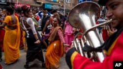 LGBTQ+ people and their supporters dance during the annual Pride parade in Kathmandu, Nepal, on Aug. 20, 2024.