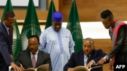 FILE- Redwan Hussien Rameto, 2nd left, representative of the Ethiopian government, and Getachew Reda, 2nd right, representative of the Tigray People's Liberation Front (TPLF), sign a peace agreement between the two parties.