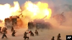 FILE - This image broadcast by North Korea's KRT on April 26, 2017, shows a "combined fire demonstration" in Wonsan, North Korea. North Korea is apparently moving to sell millions of rockets and artillery shells – many of them likely from old stock – to R