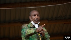 FILE - In this photo taken on October 12, 2020 Guinea President Alpha Conde addresses his supporters during a campaign rally in Kissidougou. 