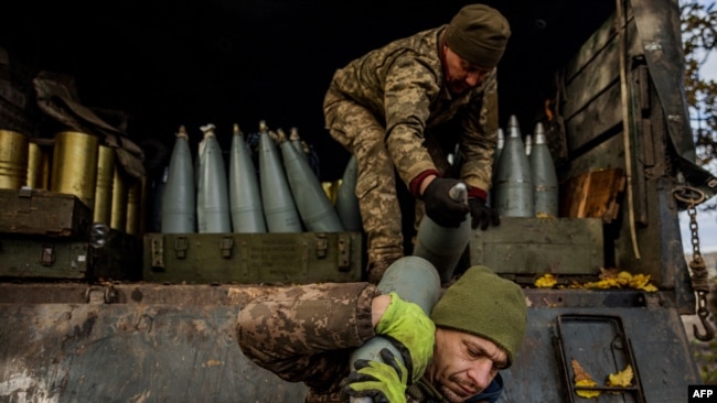 Ukrainian artillerymen unload shells from a military truck at a position on the front line near the town of Bakhmut, in eastern Ukraine's Donetsk region, on October 31, 2022, amid the Russian invasion of Ukraine.